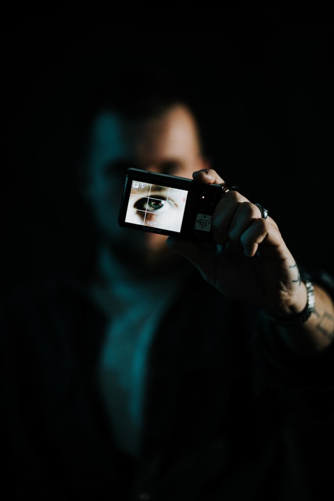 A man taking a picture of himself with a camera